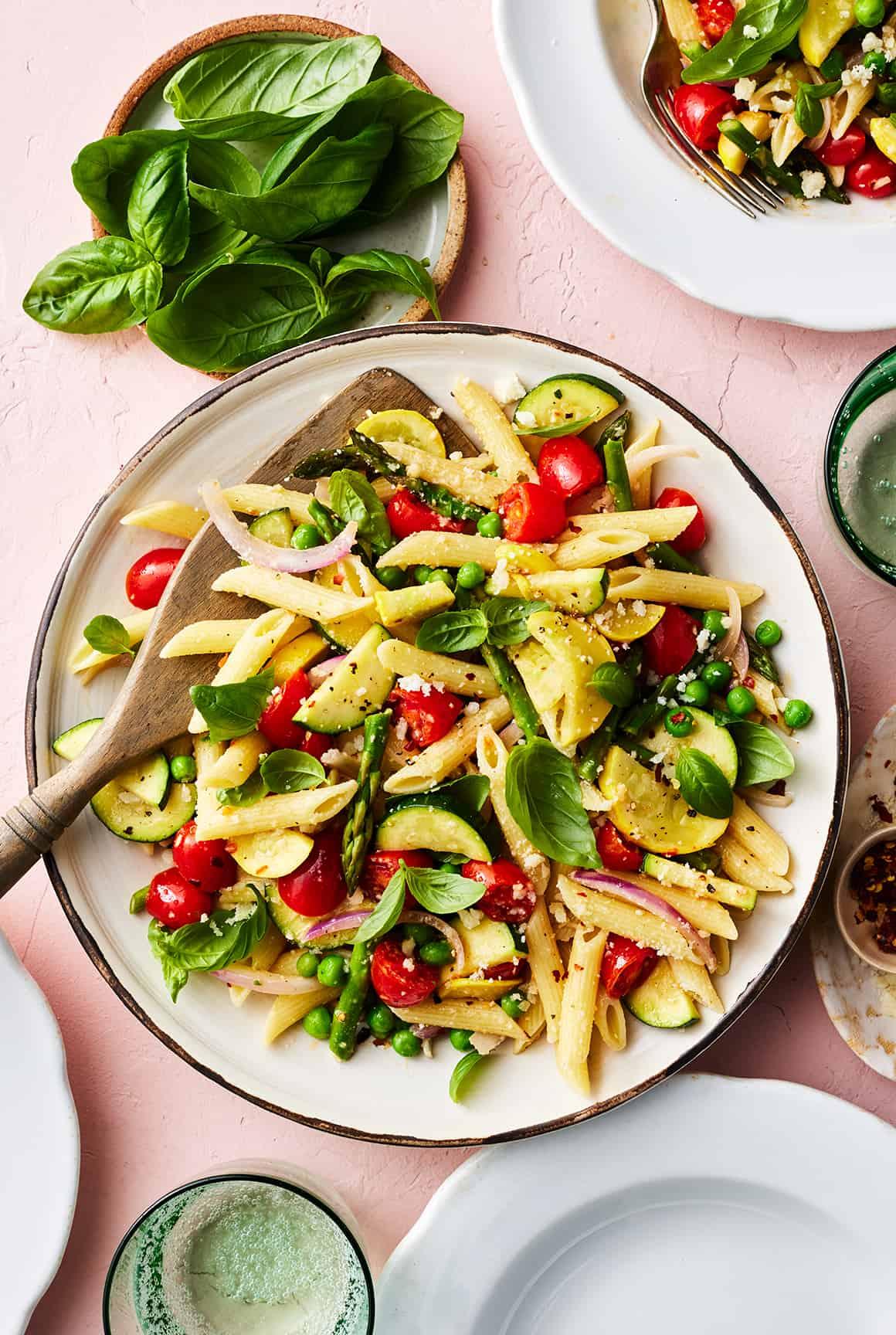 A vibrant and colorful bowl of pasta primavera with fresh vegetables