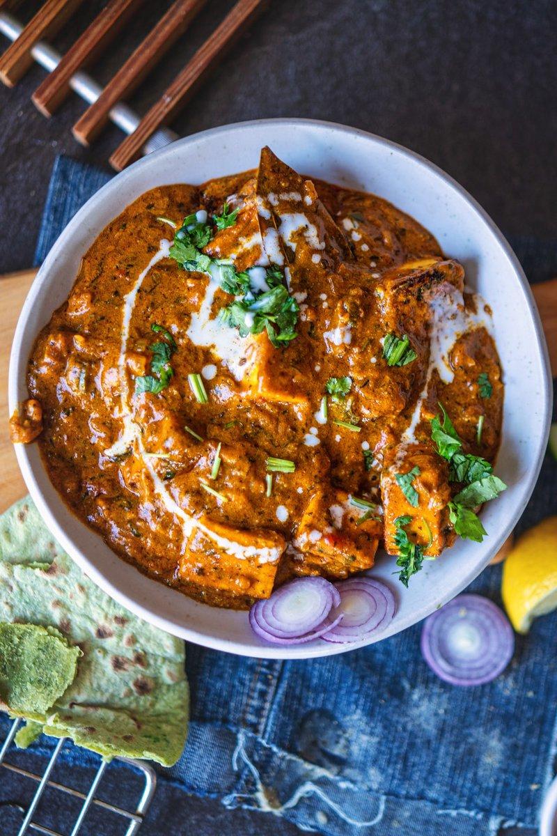 Paneer cubes marinating in a bowl of spices and yogurt, top-down view