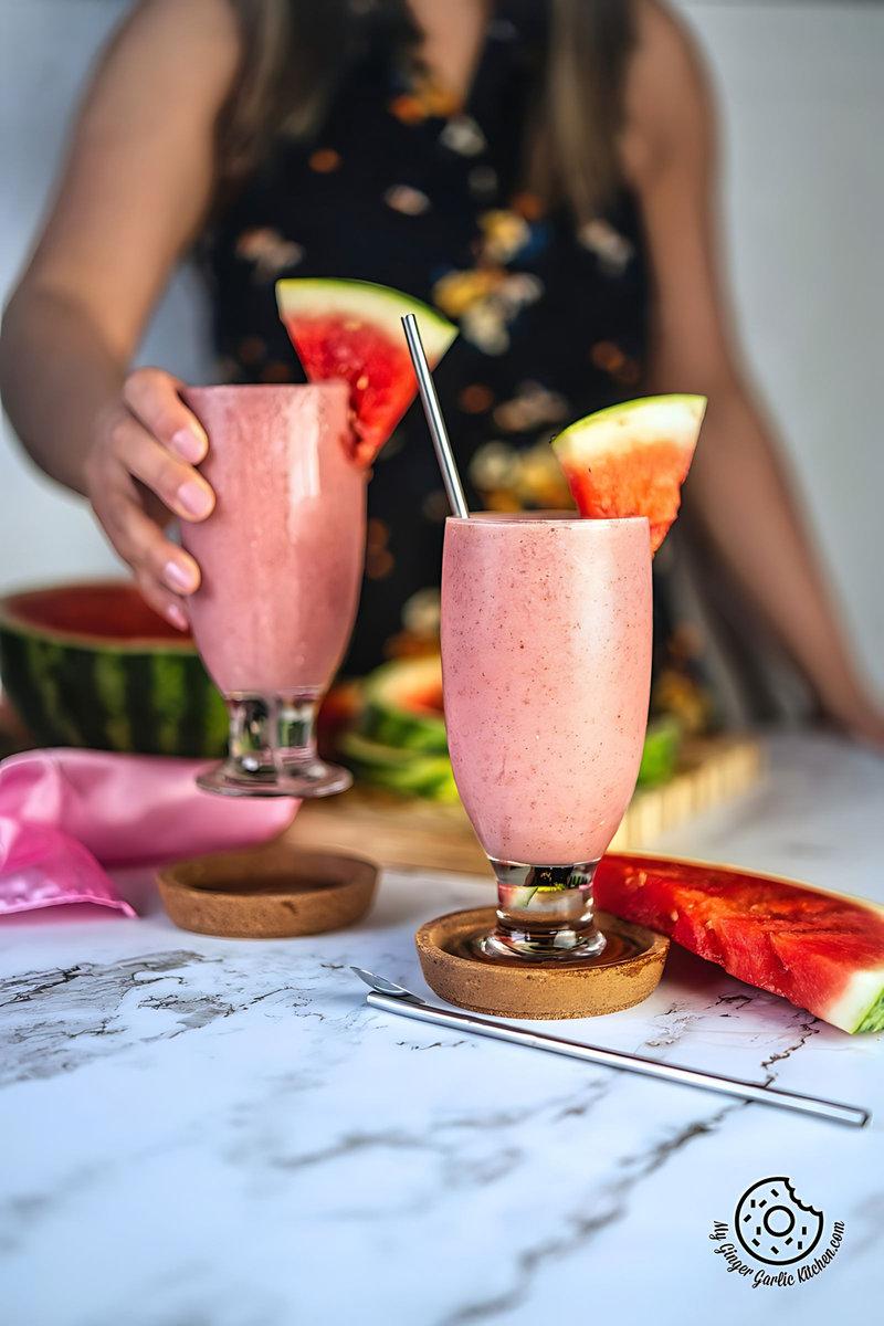 Close up of a person enjoying a refreshing watermelon smoothie
