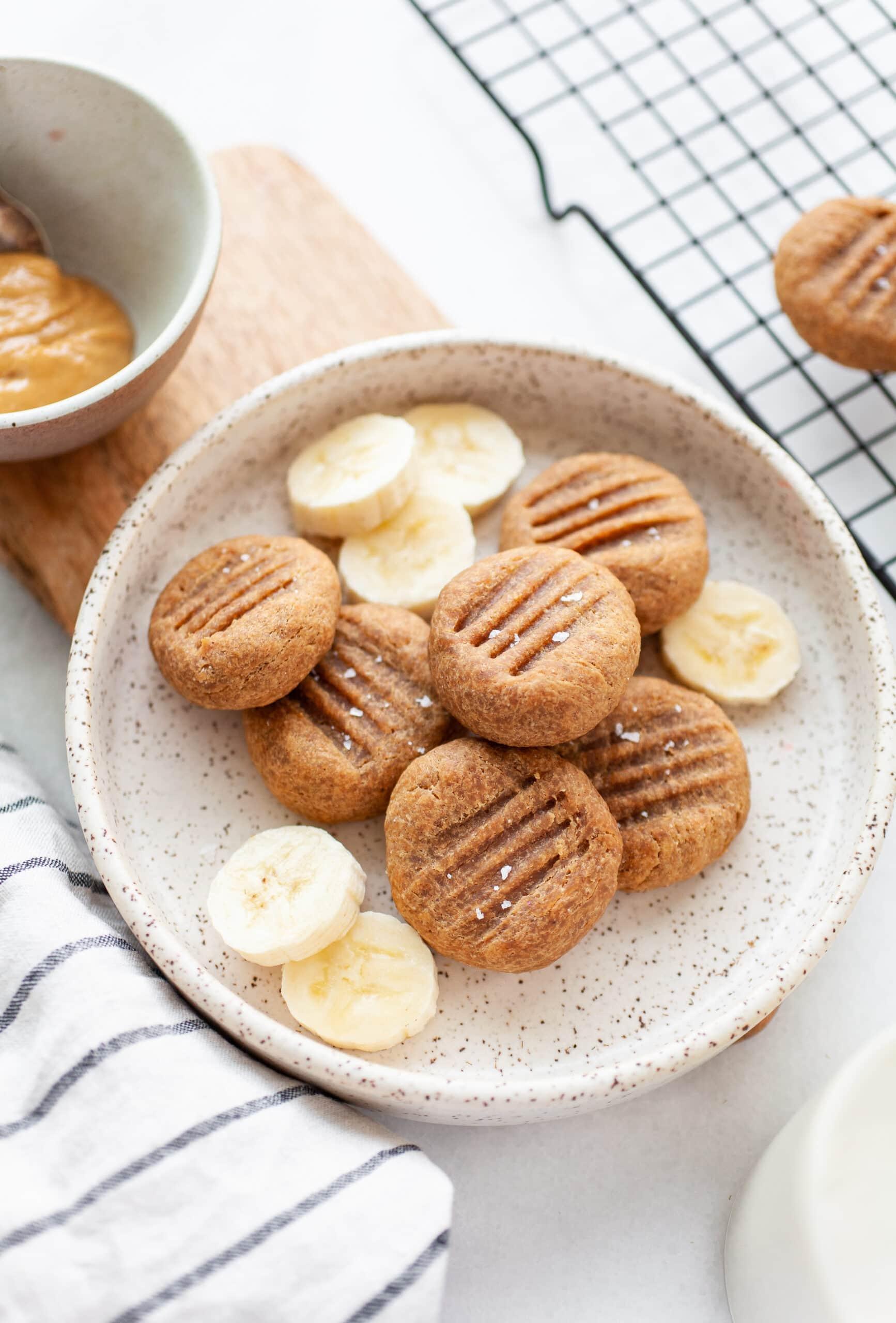 Close-up of a single peanut butter and banana cookie, showcasing its texture and ingredients.