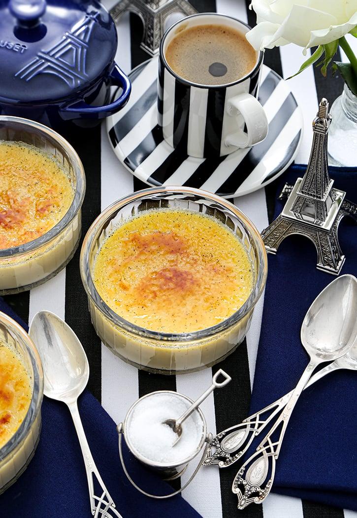 Elegant table setting with two ramekins of champagne crème brûlée