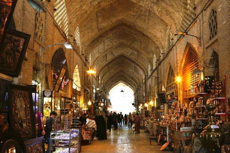 A bustling market scene in Isfahan, Iran, with baklava being sold