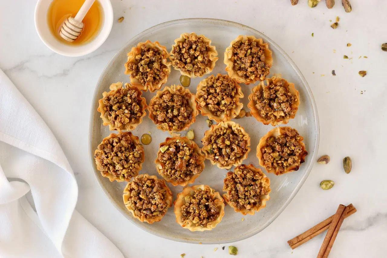 A plate of mini baklava bites arranged artfully, ready for serving