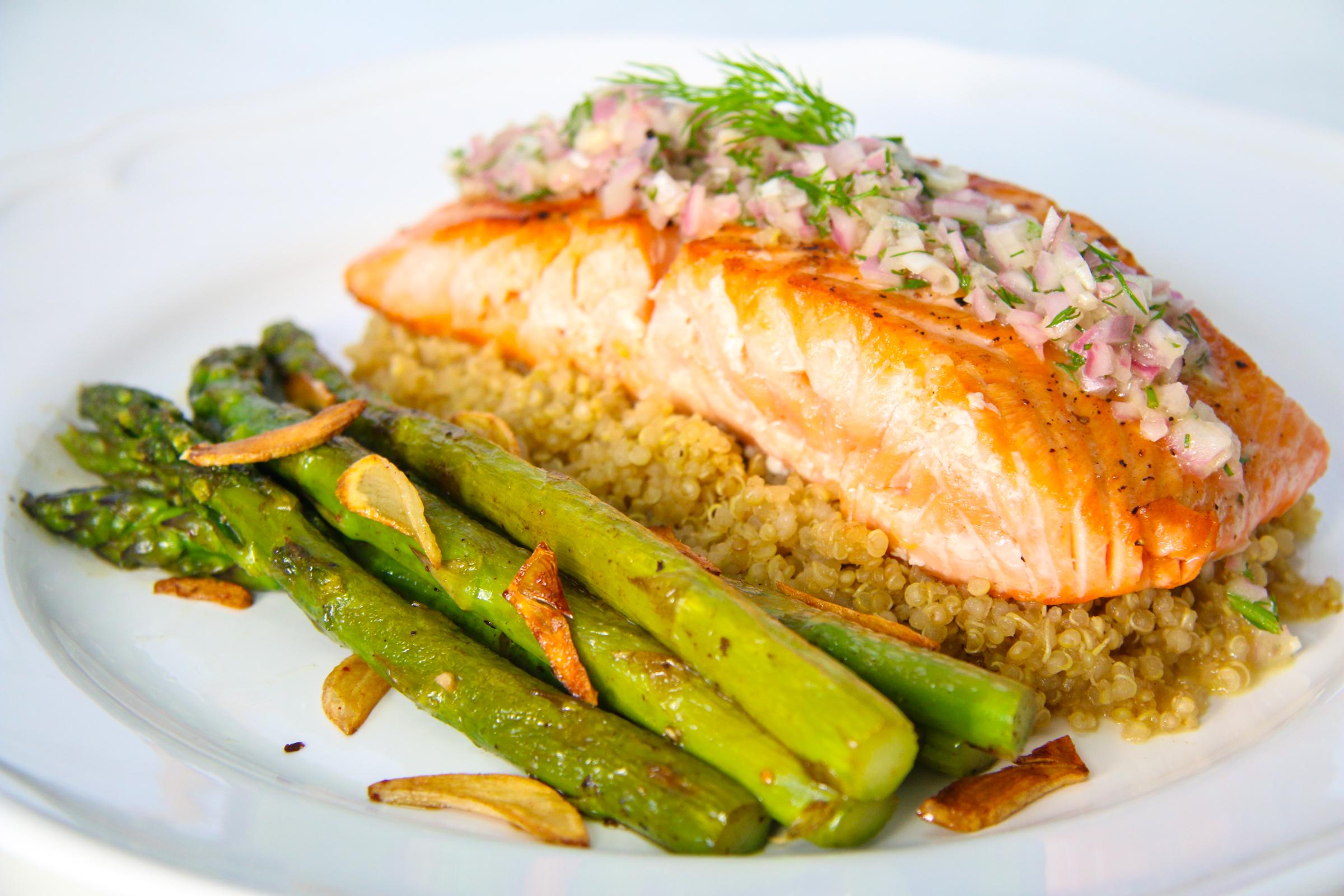 close-up shot of champagne glazed salmon with asparagus and quinoa