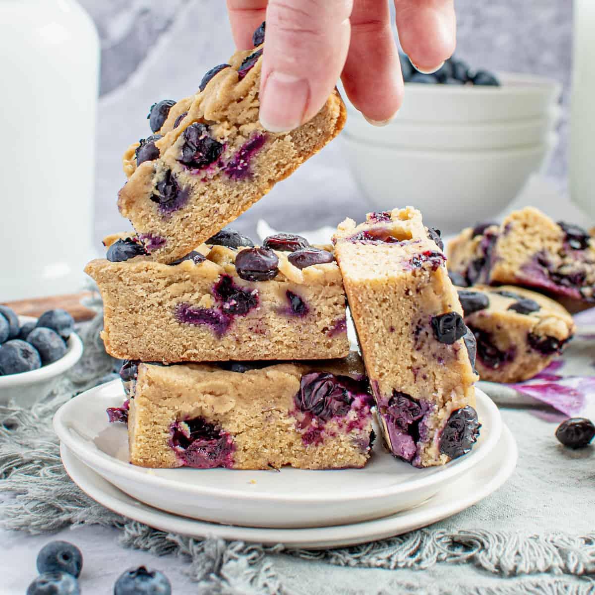 A plate of Blueberry Beetroot Blondies with a glass of milk alongside