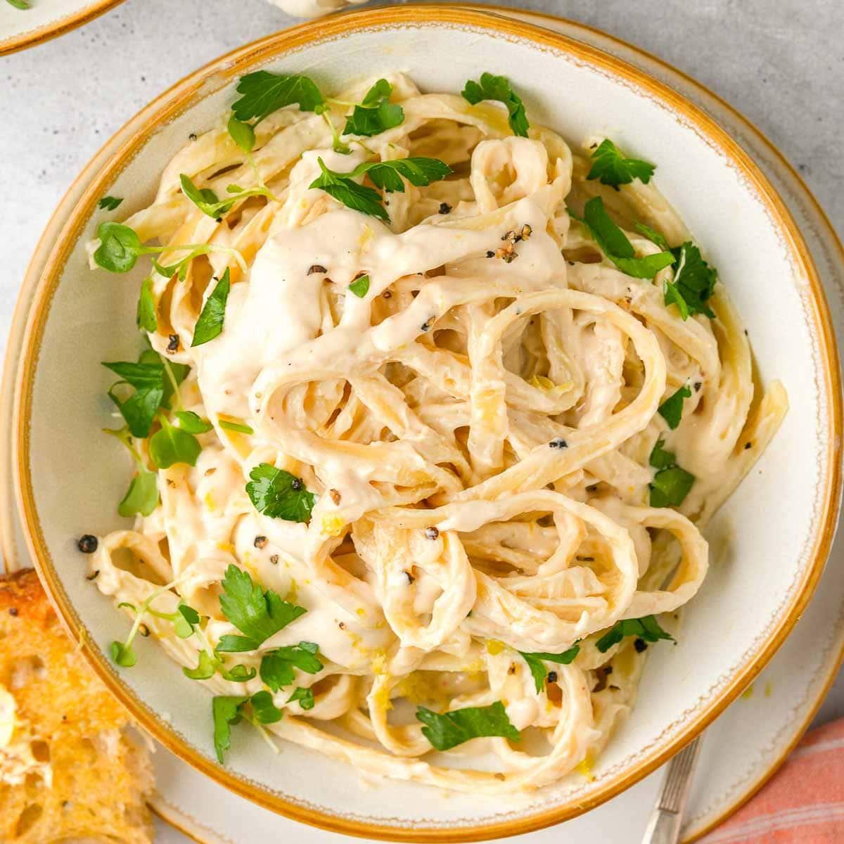 A close-up shot of the creamy alfredo sauce, showing its texture and color