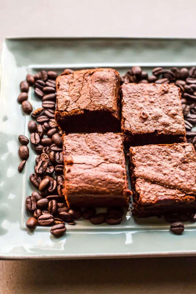 Overhead shot of a person cutting into a pan of freshly baked espresso brownies