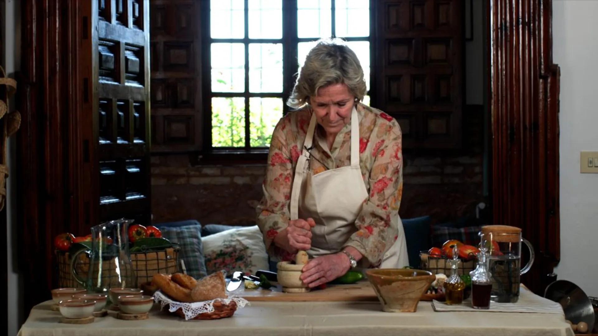 woman preparing gazpacho in kitchen