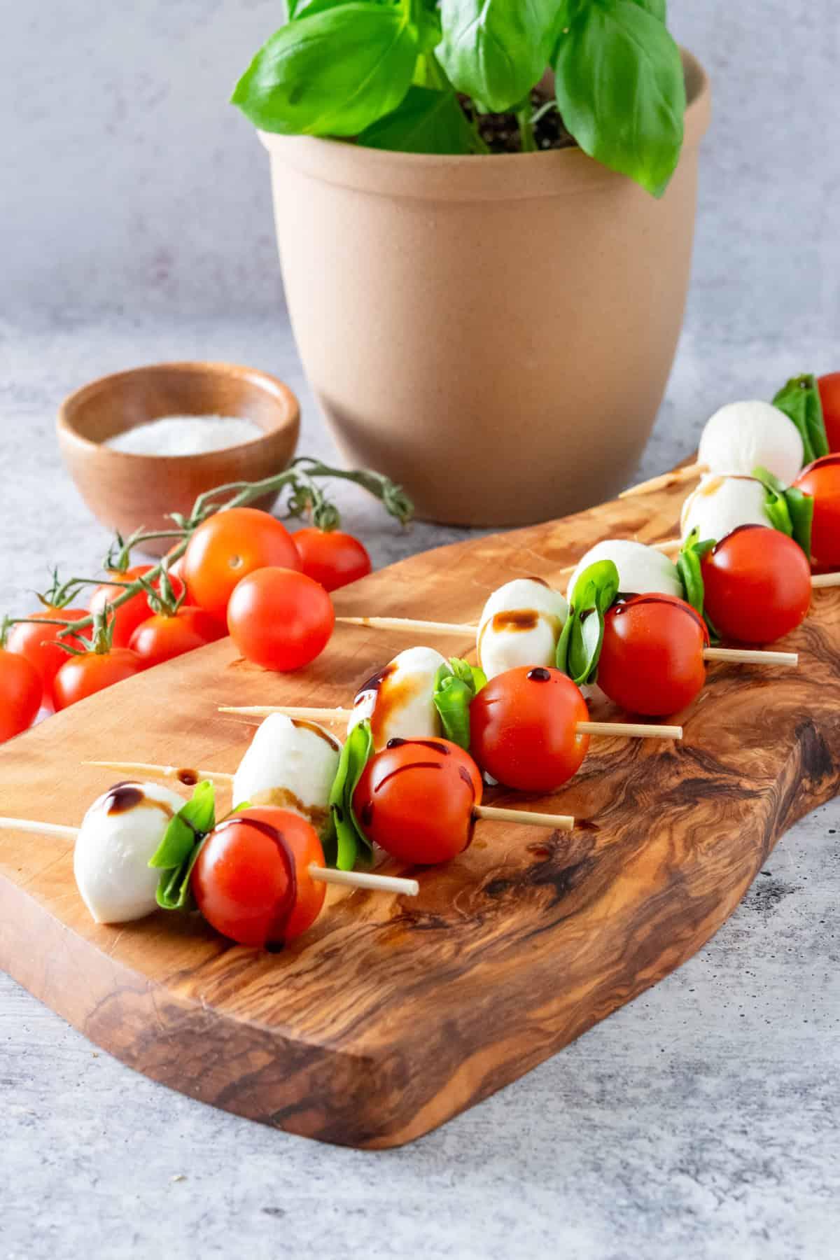 close-up shot of Caprese salad skewers arranged on a rustic wooden platter