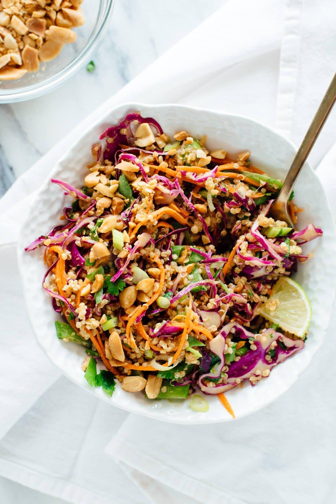 Close-up shot of quinoa salad with tofu and peanut sauce, showing the texture and vibrant colors.