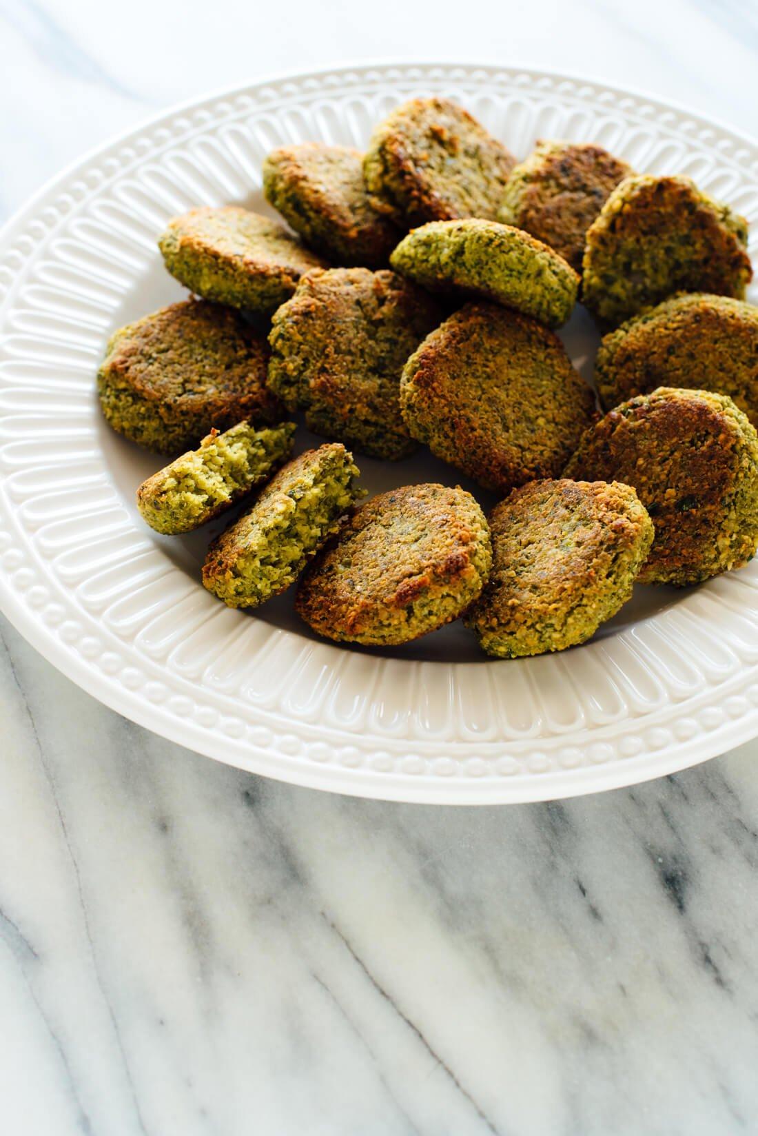 Hands shaping falafel balls, highlighting the texture of the chickpea mixture
