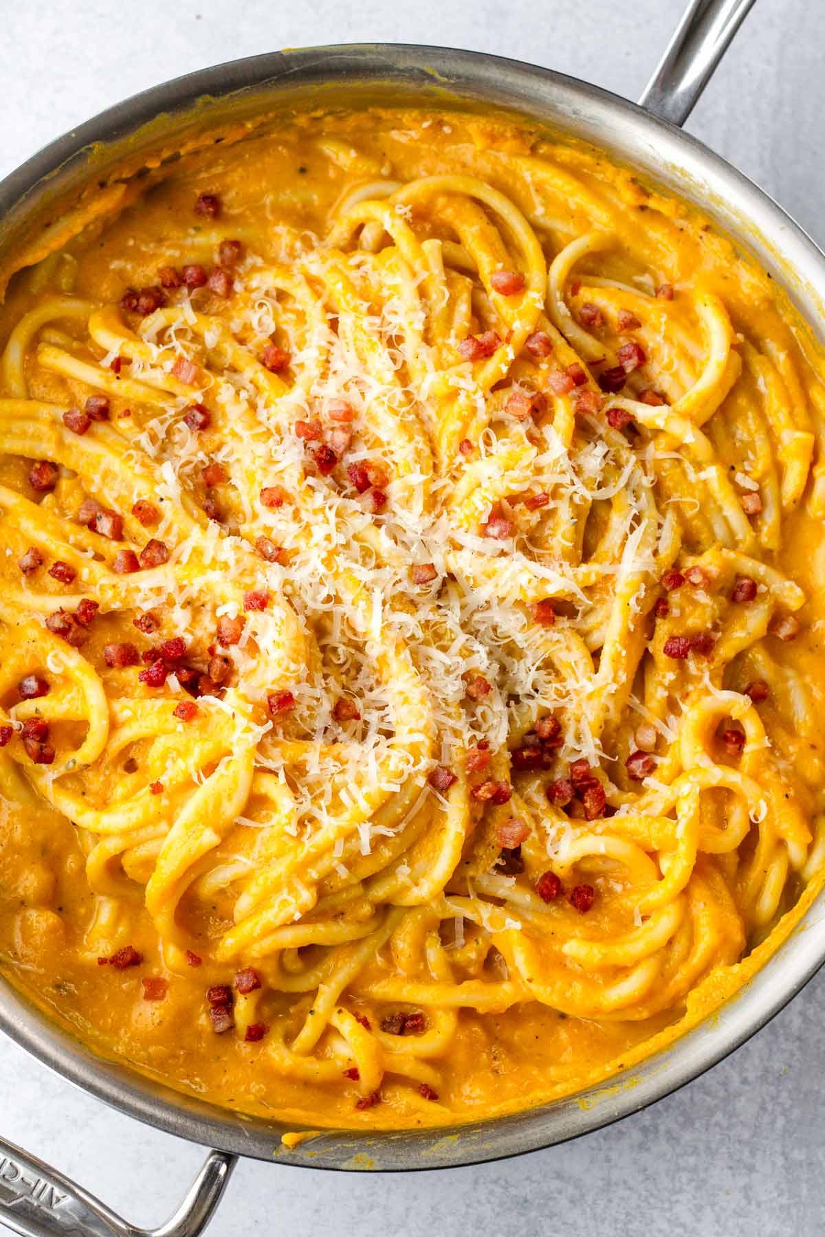 Close-up of butternut squash pasta dish with pancetta and parmesan