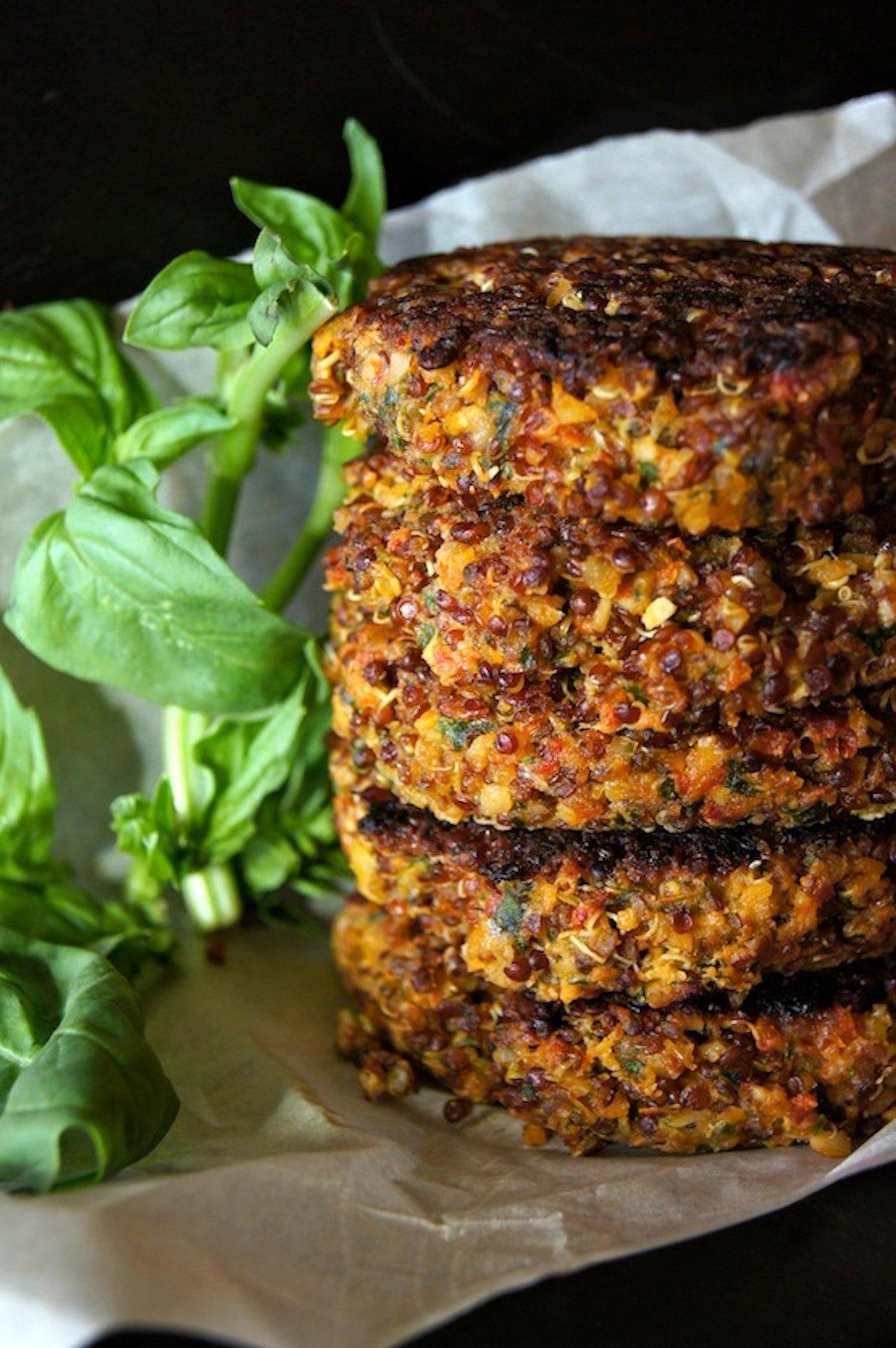 A stack of freshly cooked quinoa veggie burgers.