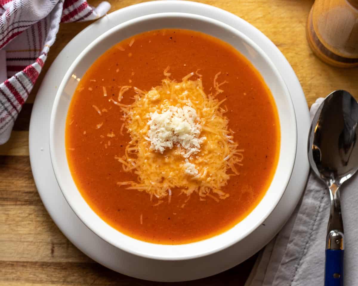 A person enjoying a bowl of Keto Roasted Red Pepper and Tomato Soup