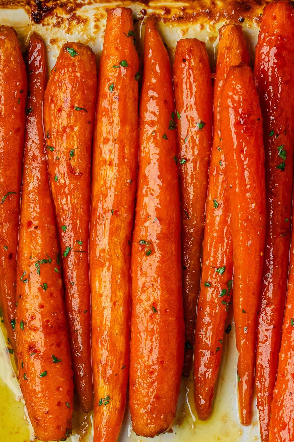 close-up of roasted sweet paprika and honey glazed carrots on a baking sheet