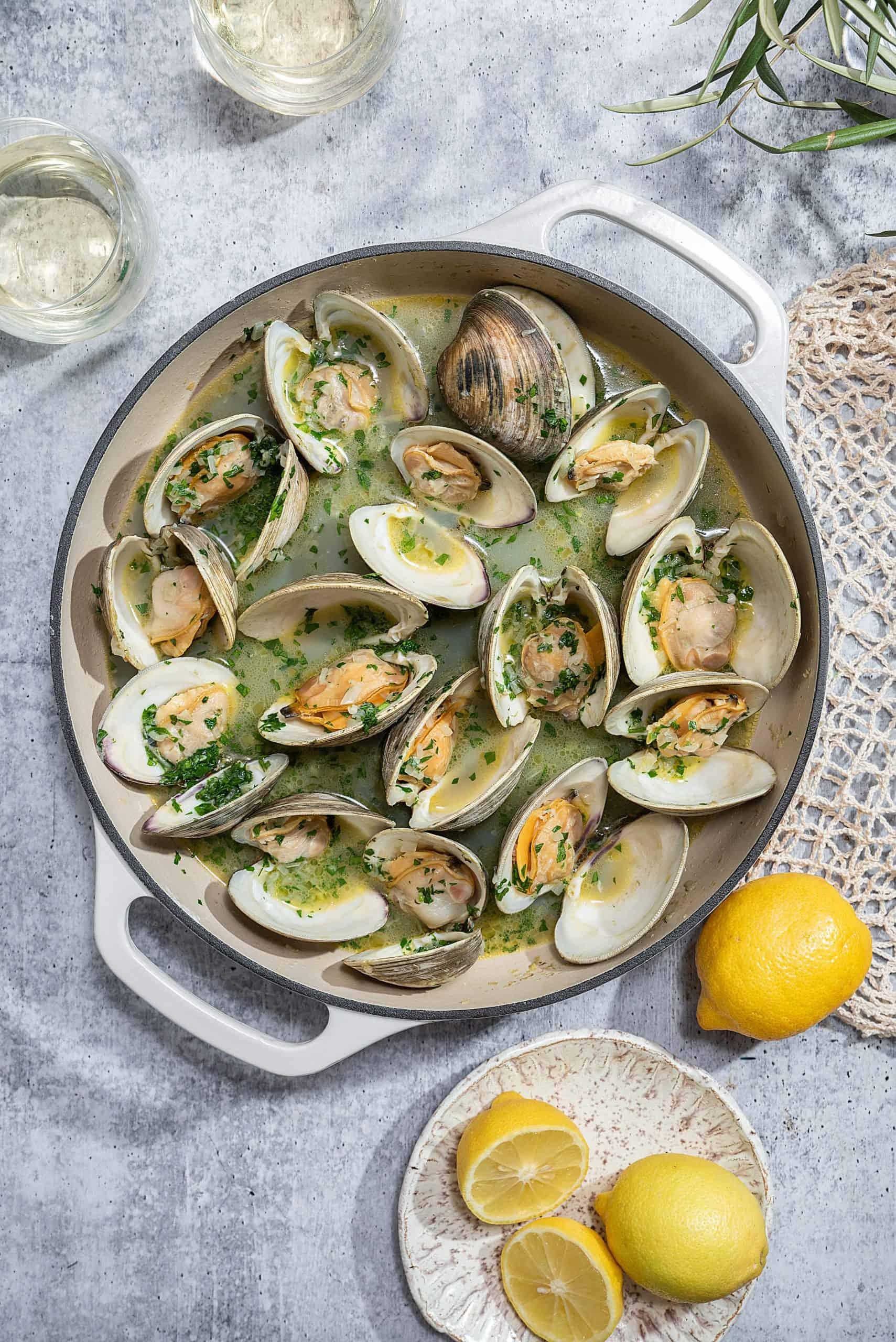 Close up of roasted clams, glistening with butter and wine