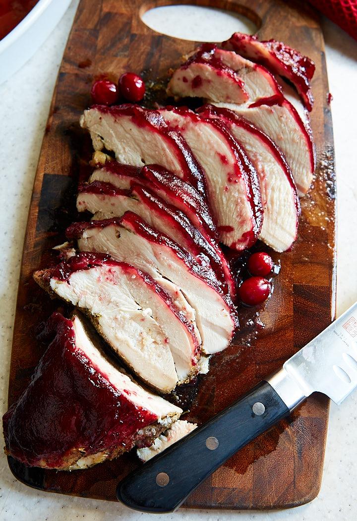 Close up shot of Champagne Cranberry Sauce drizzled over roasted turkey