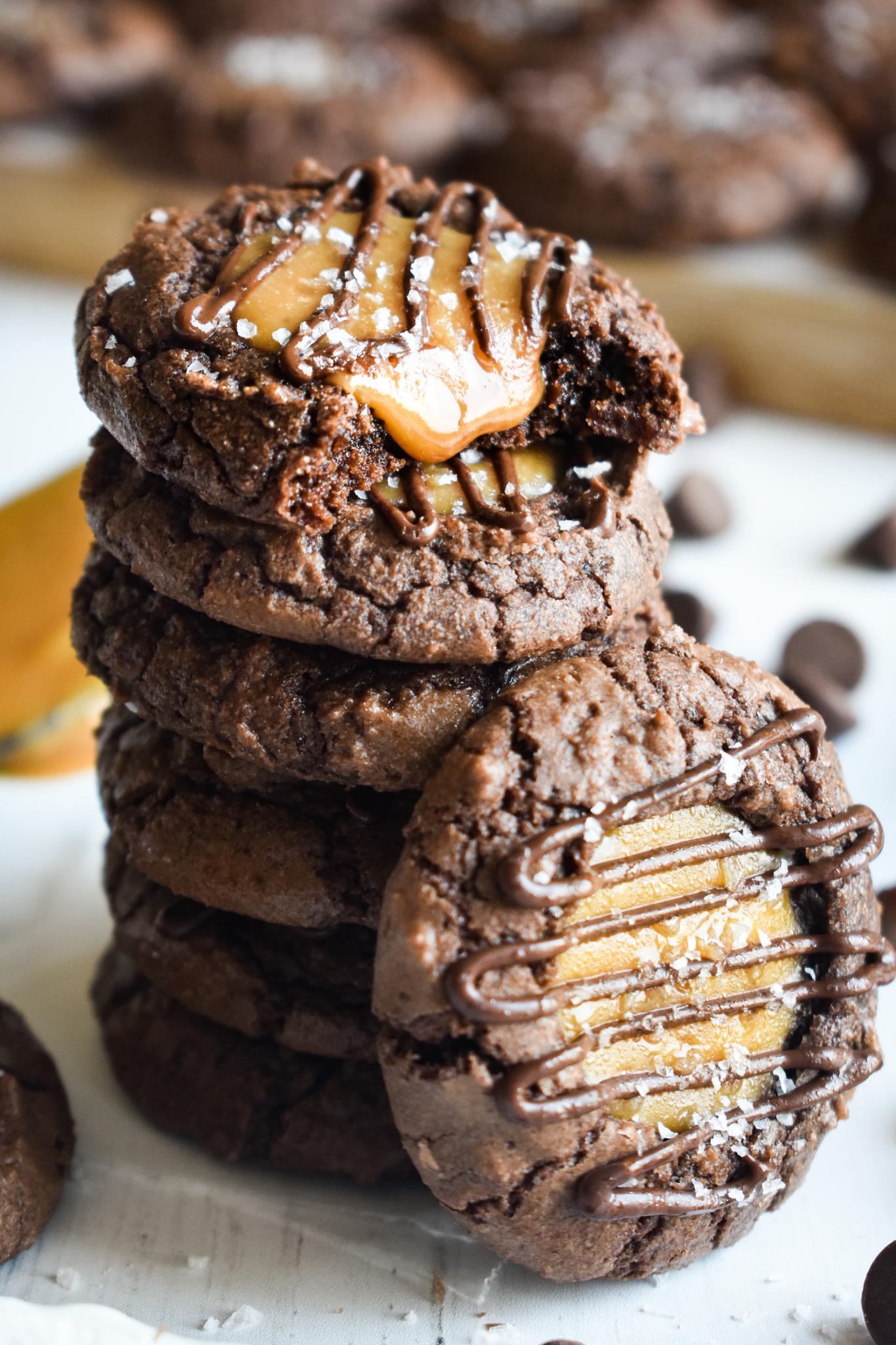 A close-up shot of a single salted caramel brownie cookie, showing the caramel swirl and sea salt