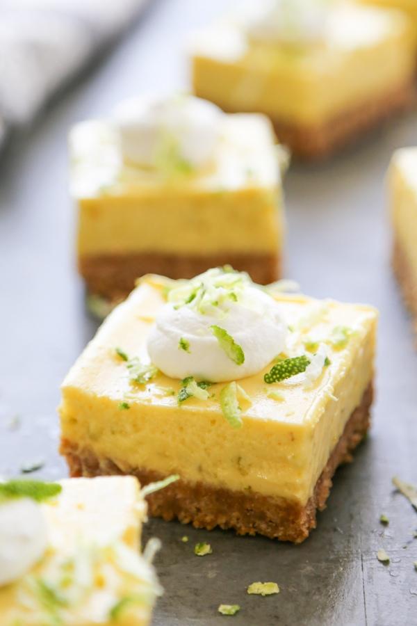 Close-up shot of key lime brownies with whipped cream frosting