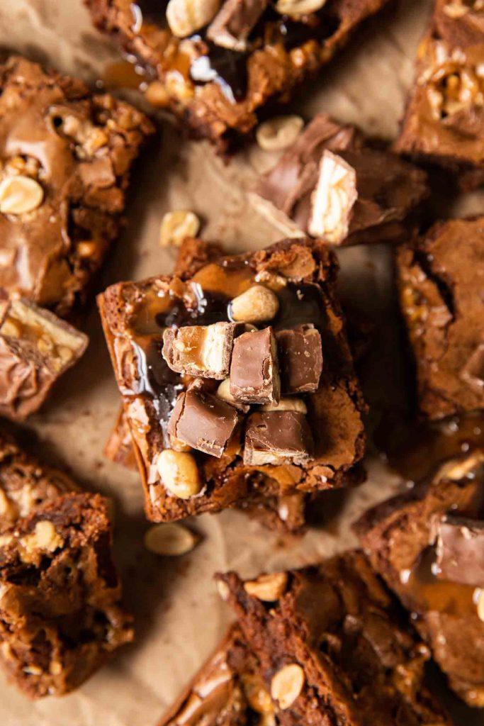 Close-up shot of a freshly baked batch of Snickers brownies