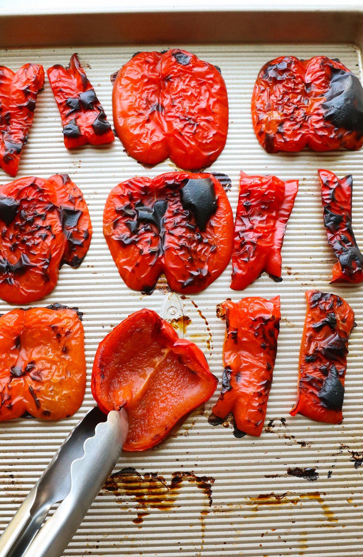 close-up of roasted red peppers on a baking sheet