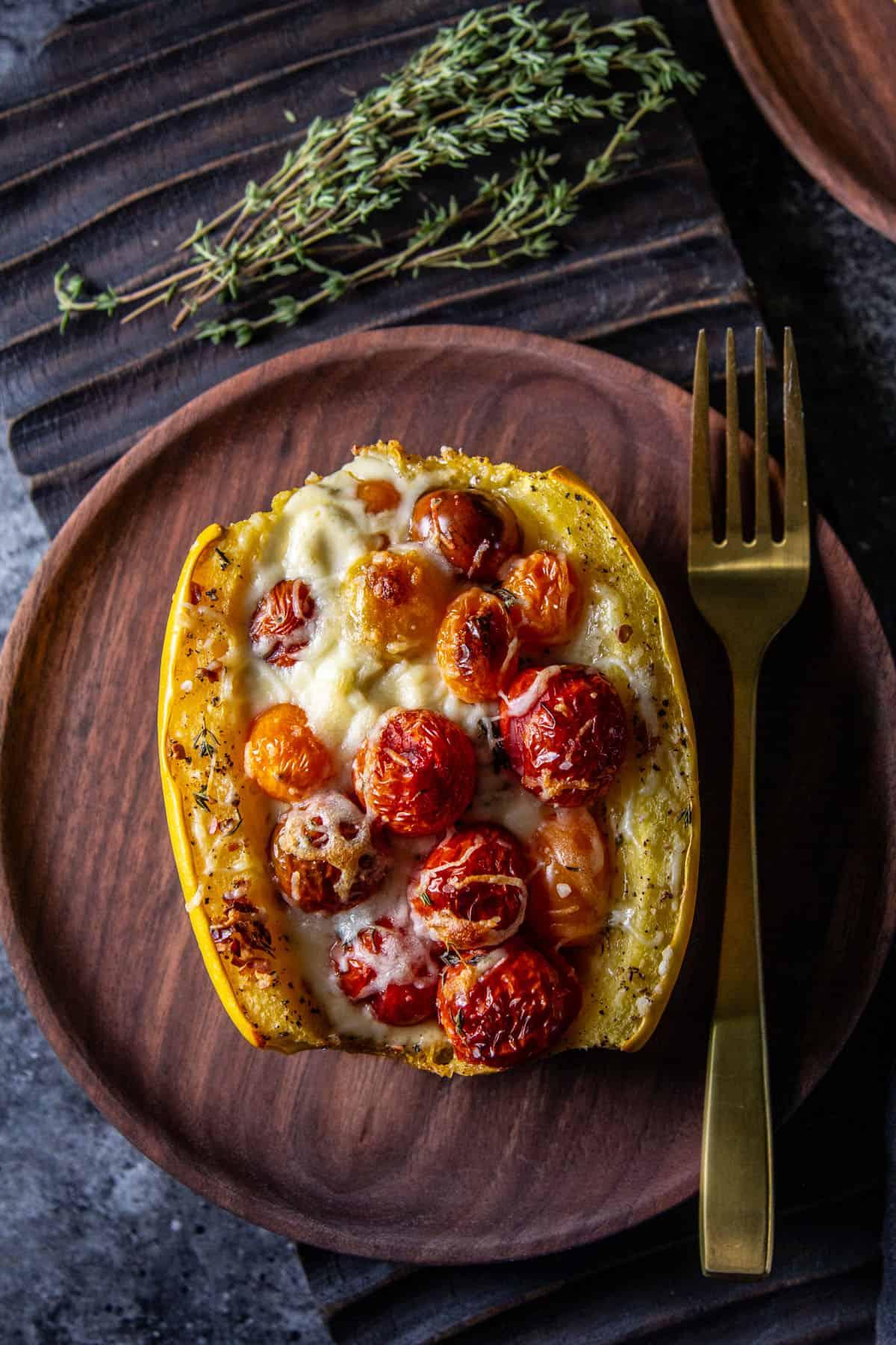 Overhead shot of the finished spaghetti squash pizza on a wooden cutting board