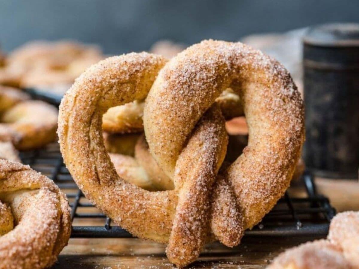 close up shot of pretzels being coated with cinnamon sugar