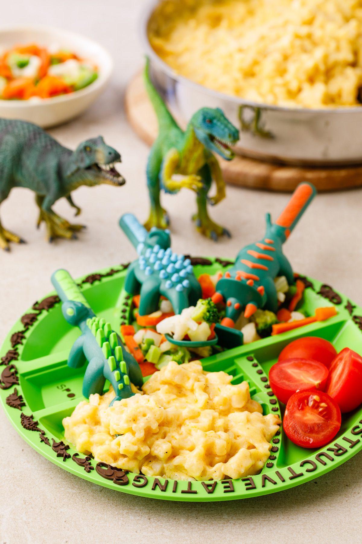 A bowl of dinosaur Mac and cheese with a playful, slightly messy presentation