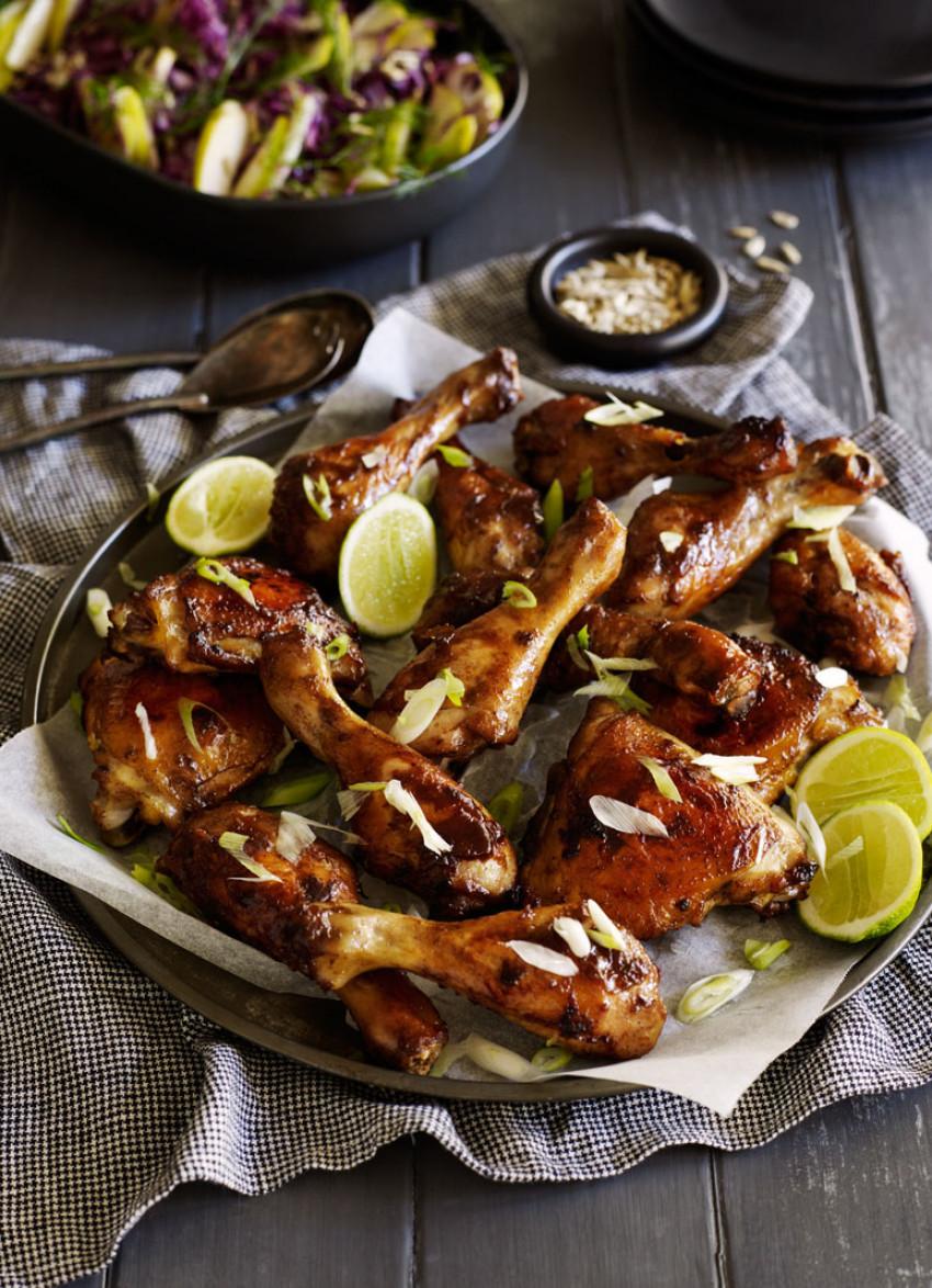 A table full of friends enjoying a meal of five-spice wings and Asian slaw