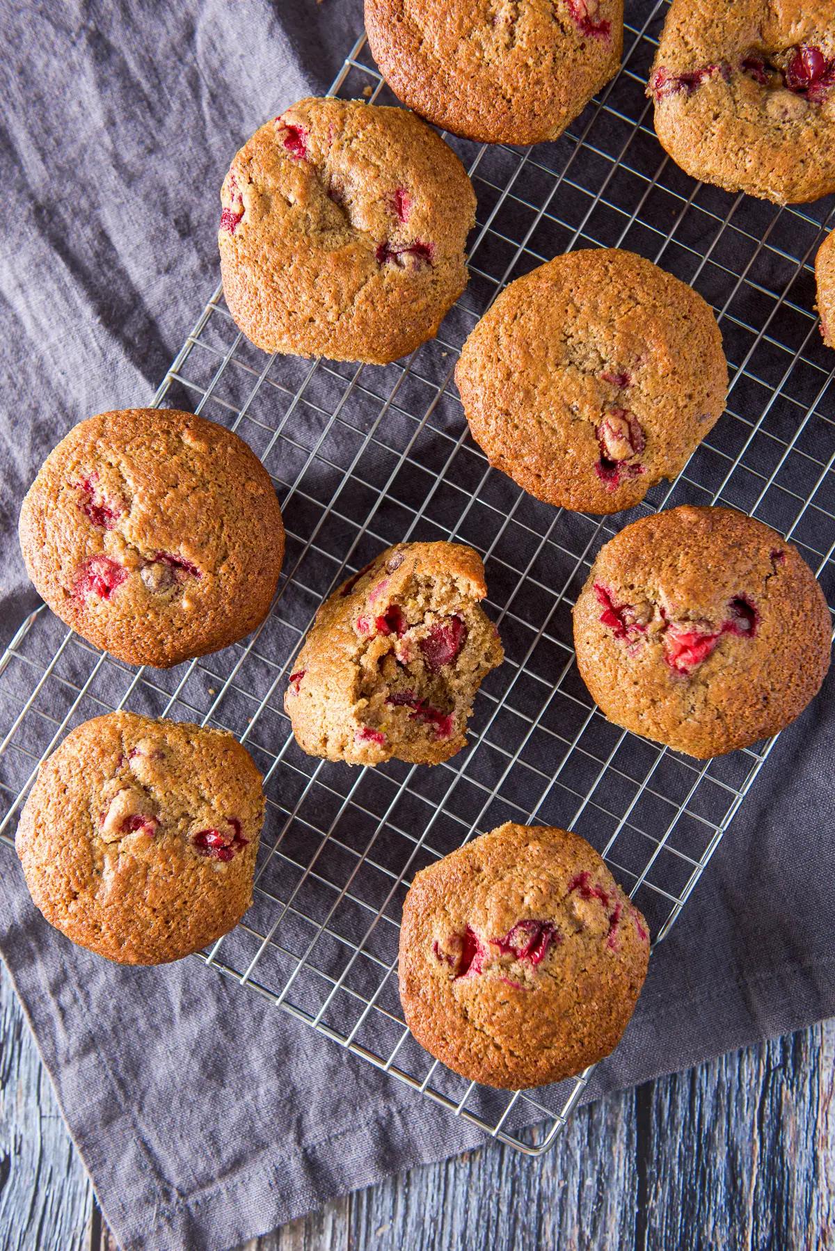 overhead shot of a batch of cranberry orange muffins cooling on a wire rack