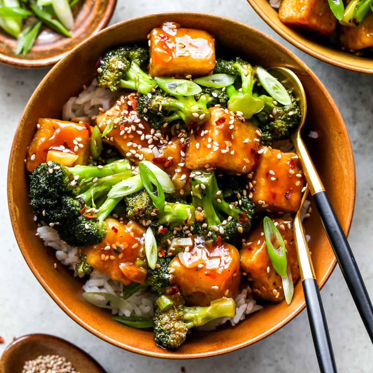 Close-up shot of General Tso's Tofu with Crispy Broccoli, showcasing the texture and glossy sauce.