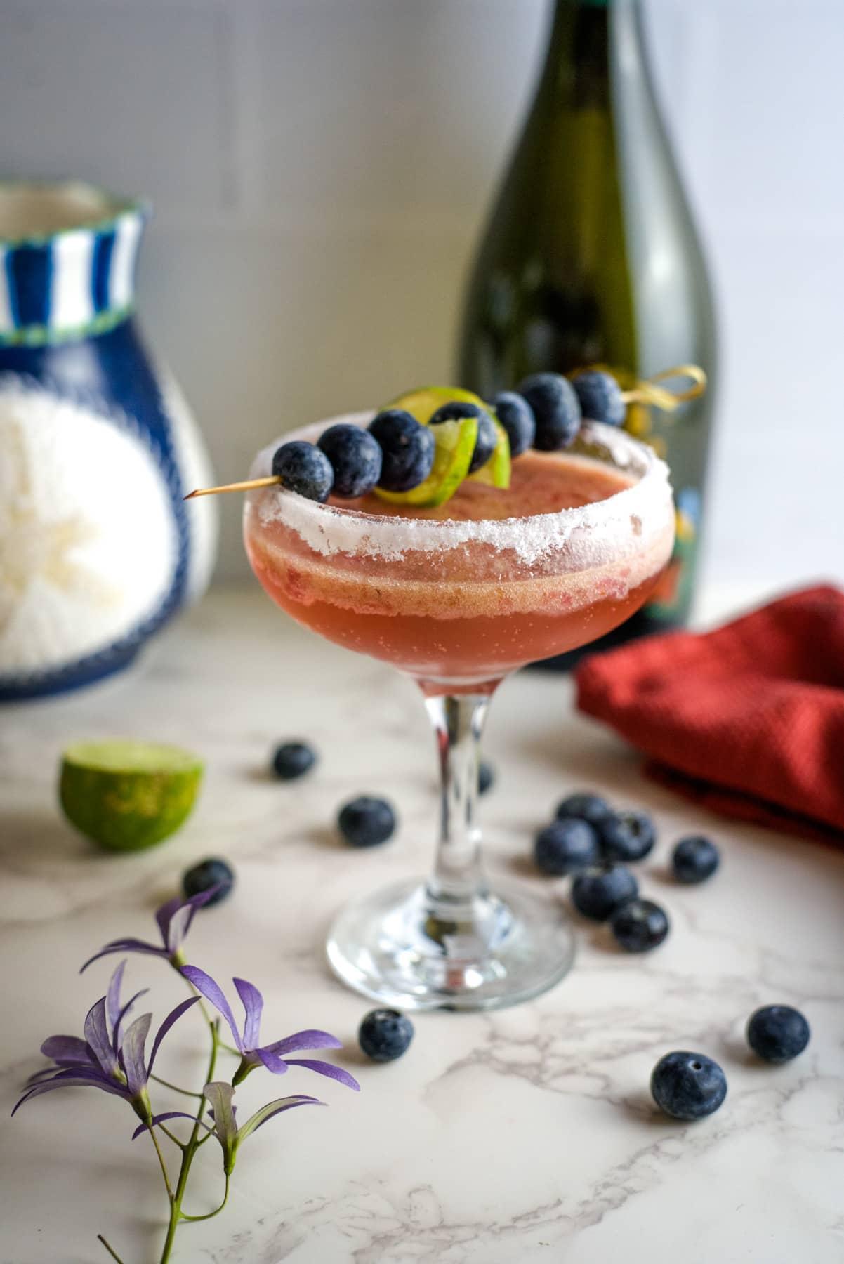 close-up of cilantro blueberry mimosa with garnish