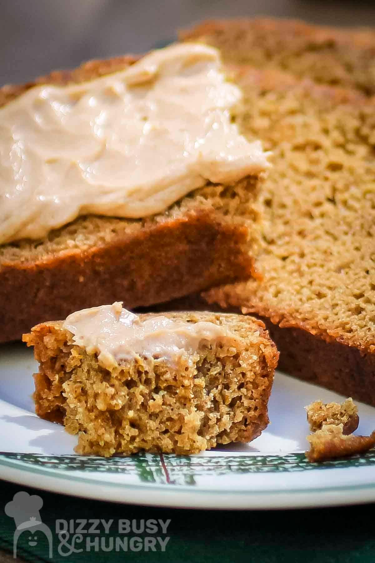 Close-up shot of a slice of gingerbread casserole with cream cheese frosting