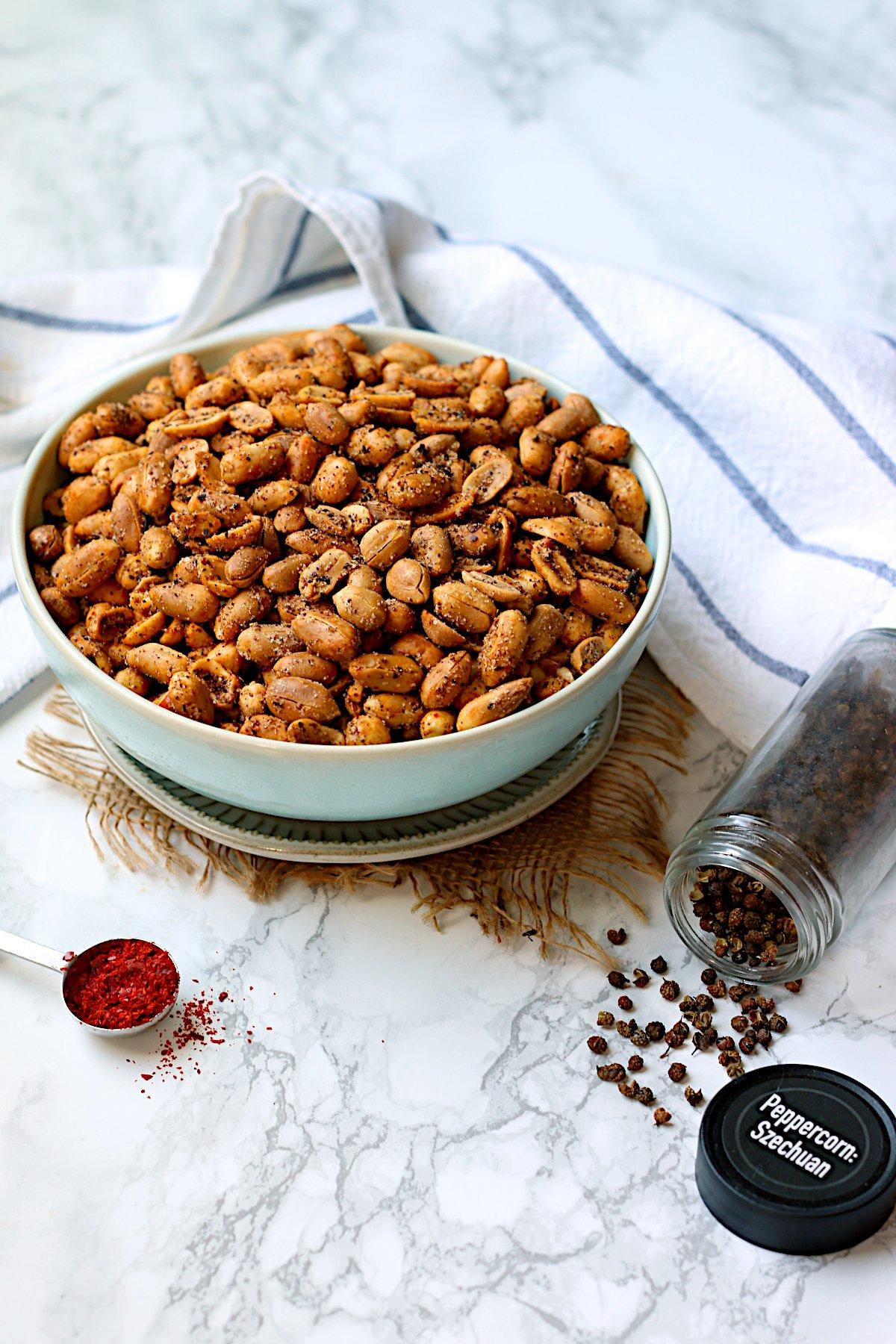 A bowl of roasted peanuts with a sprinkle of five-spice powder