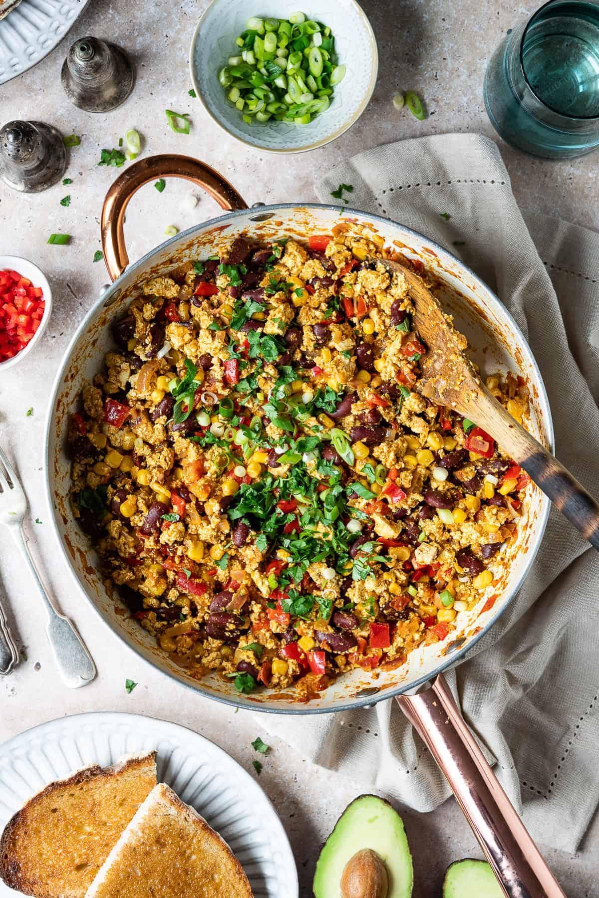 A colorful and appetizing tofu scramble with Mexican spices and vegetables in a skillet