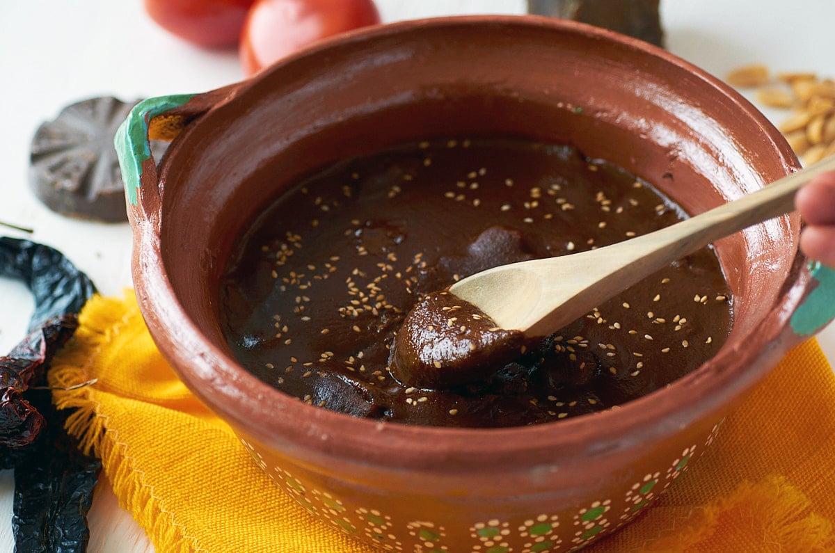 authentic mole poblano sauce simmering in a clay pot