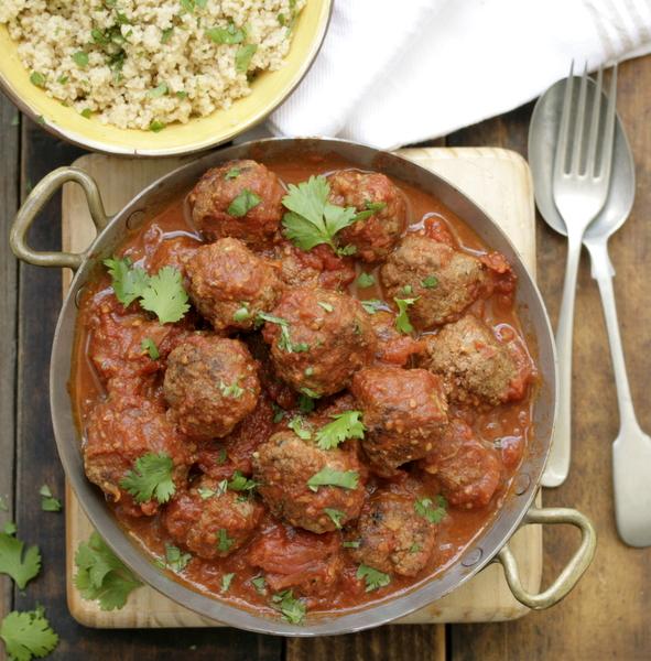 Close-up of herby köttbullar with couscous, garnished with fresh herbs