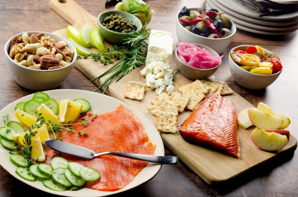 Thinly sliced Champagne Citrus Cured Salmon arranged artfully on a serving platter