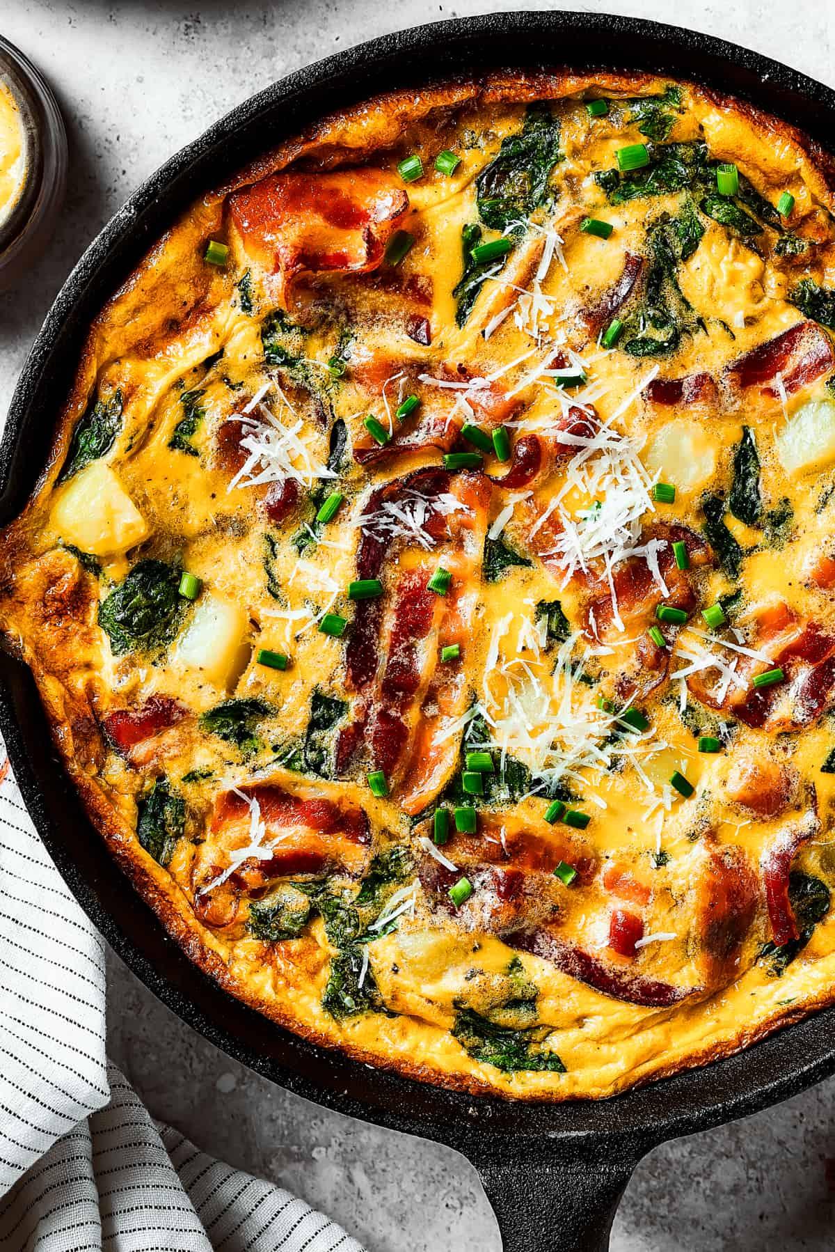 Close-up shot of a slice of potato and bacon frittata