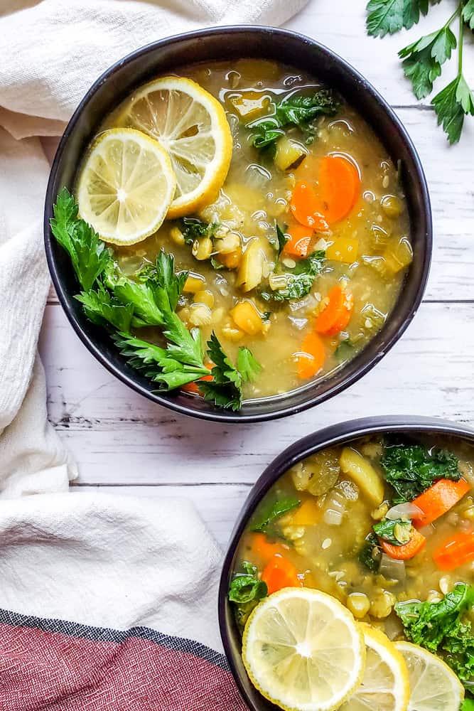 overhead shot of a table setting with bowls of apricot and rosemary lentil soup and spoons