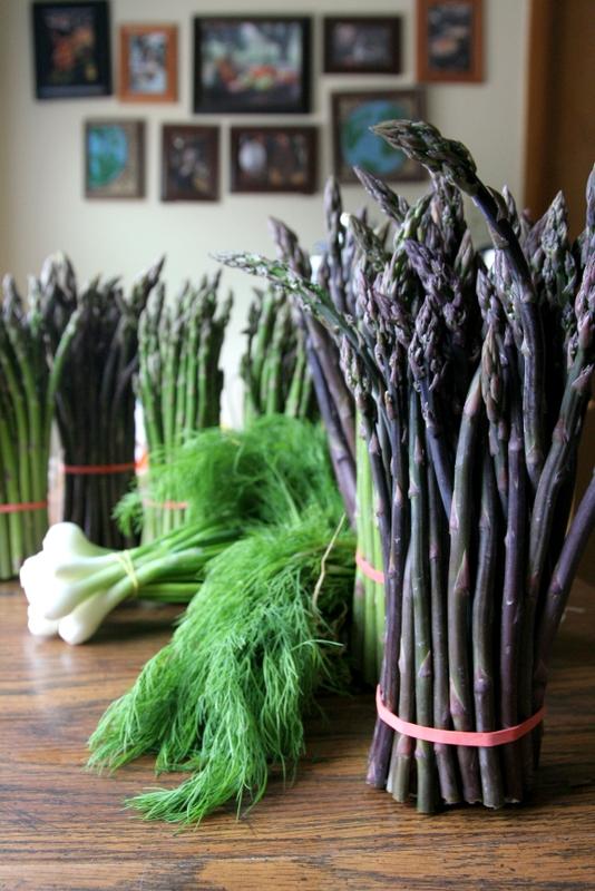 Freshly picked asparagus spears displayed at a farmers market