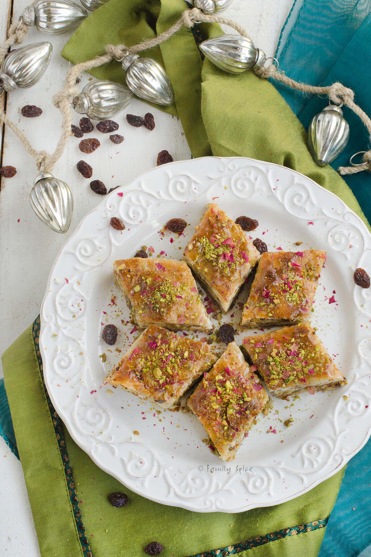 A beautifully presented platter of Persian Baklava, garnished with pistachios and crystallized ginger