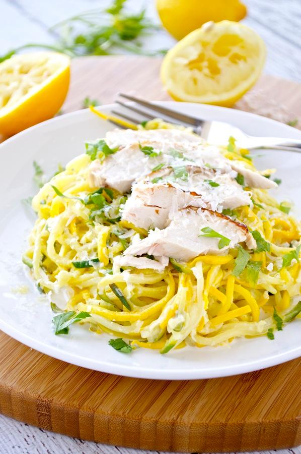 A bowl of zoodles with creamy lemon sauce and asparagus, ready to be eaten