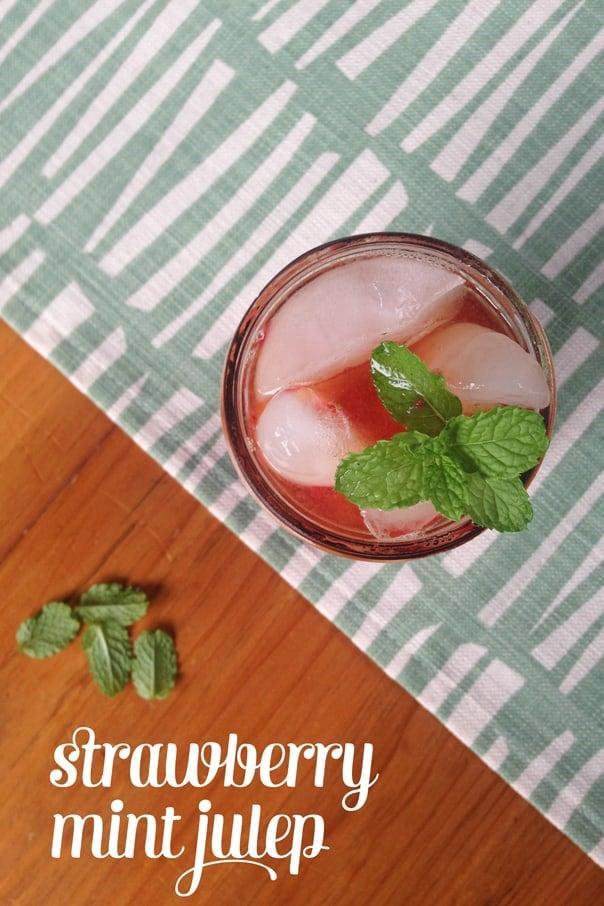Ingredients for Strawberry Mint Julep laid out on a wooden surface