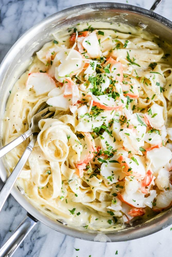 Romantic setting of a dinner table with lobster fettuccine alfredo