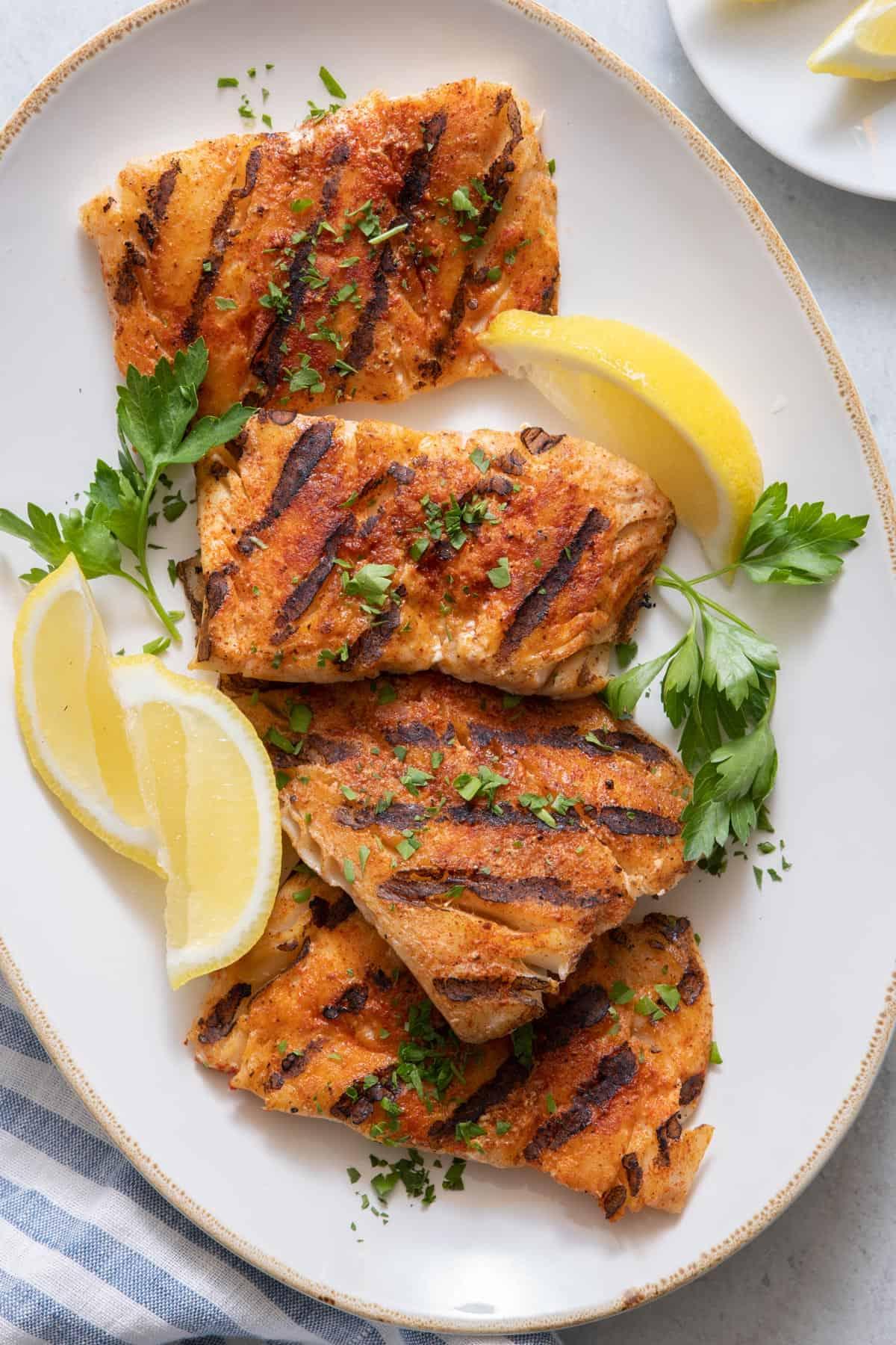 cajun spice grilled cod with lemon wedges