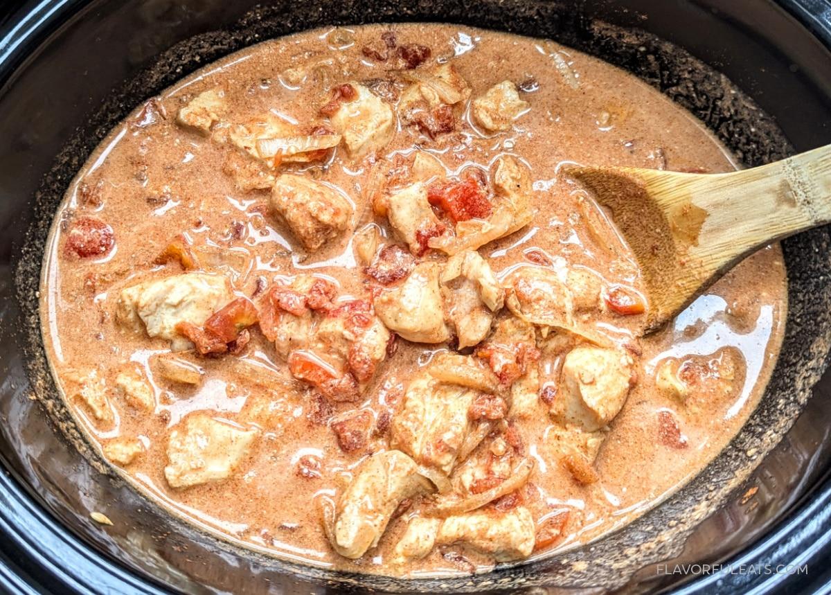 Close-up shot of a slow cooker chicken paprikash stew with paprika dusting