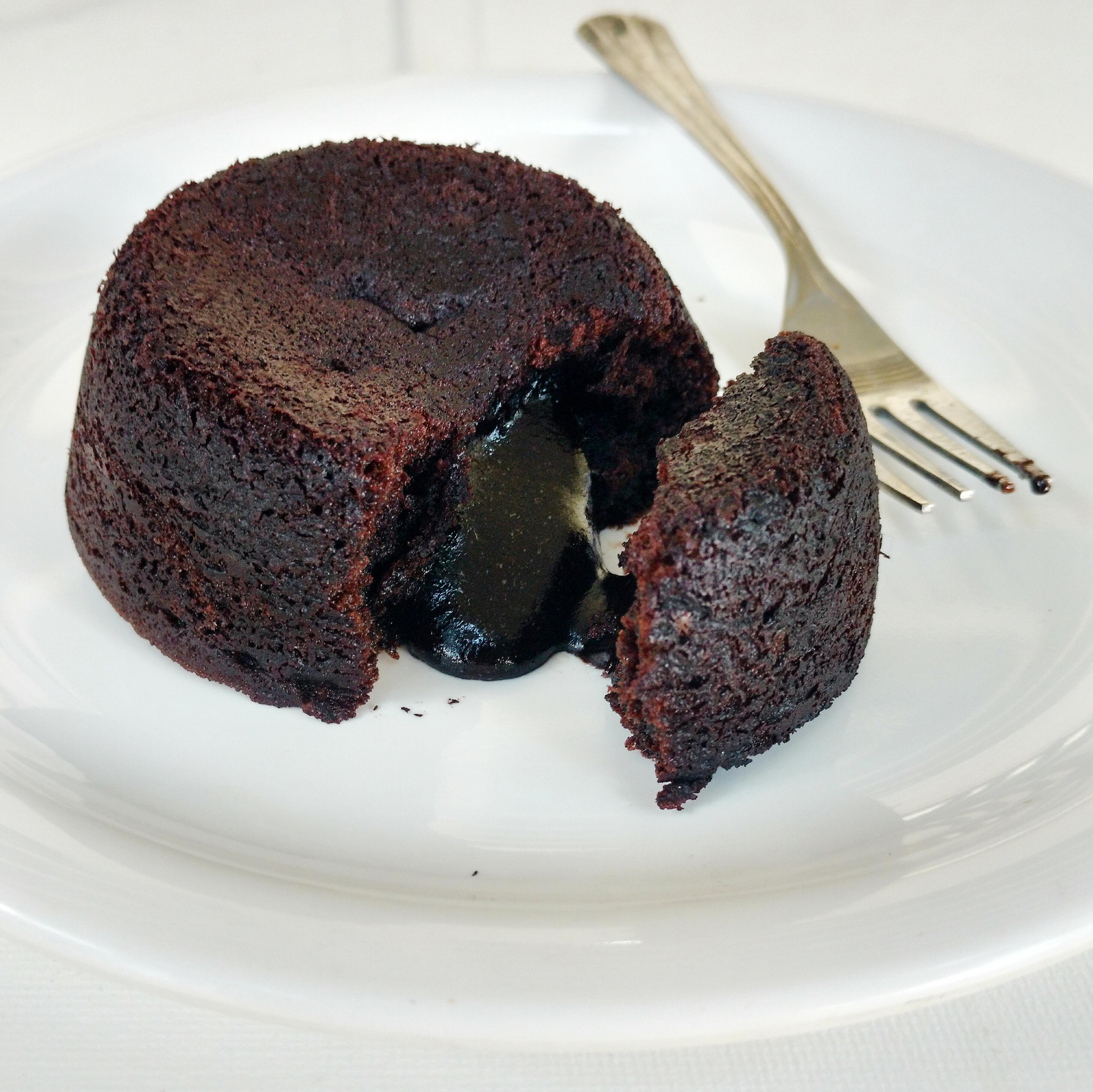 A group of people enjoying slices of molten chocolate cake