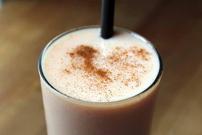 Close-up shot of the Papaya Orange Ginger Smoothie being poured into a glass