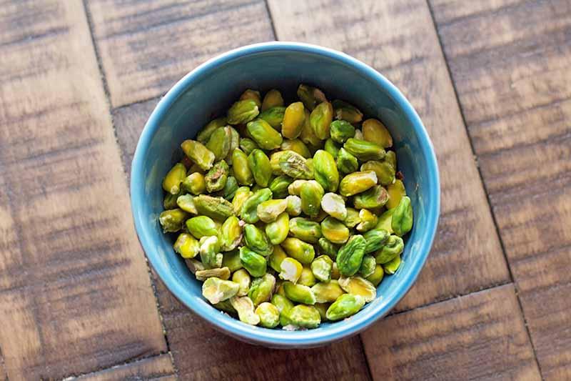overhead shot of a bowl of keto pistachio soup garnished with chopped pistachios